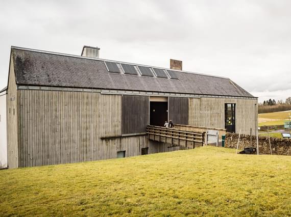Two visitors walking through the entrance of the National Museum of Rural Life.