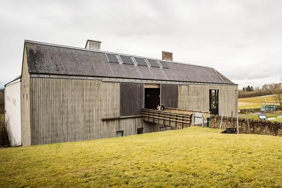 Two visitors walking through the entrance of the National Museum of Rural Life.
