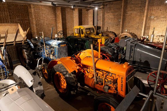 A group of tractors on display in the Tractor store at the National Museum of Rural Life.