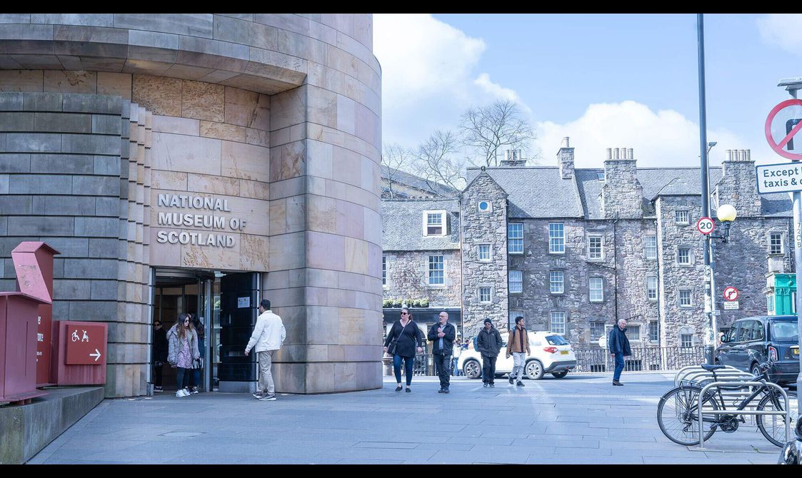 Visitors walking through the Tower Entrance of the National Museum of Scotland.