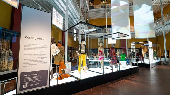A view of mannequins in display, dressed in fashionable attire from the period in focus.