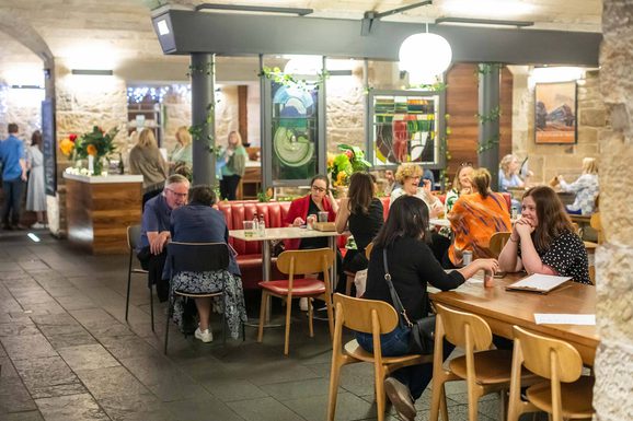 People sitting in a restaurant eating food.