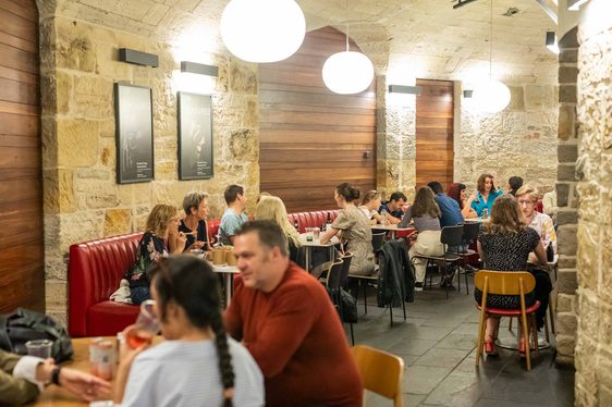 People sitting in a restuarant eating food.