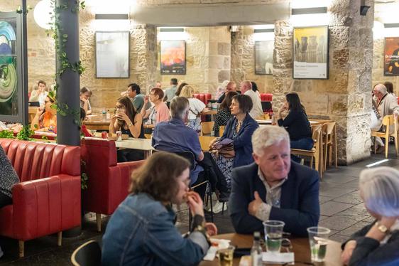 People sitting in a restaurant eating food.