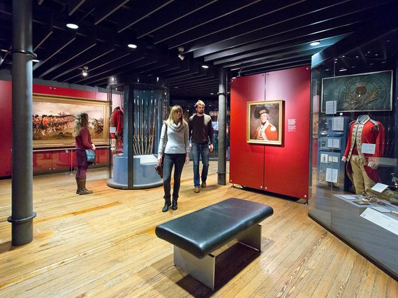 Three visitors look at displays in one of the galleries at the National War Museum.
