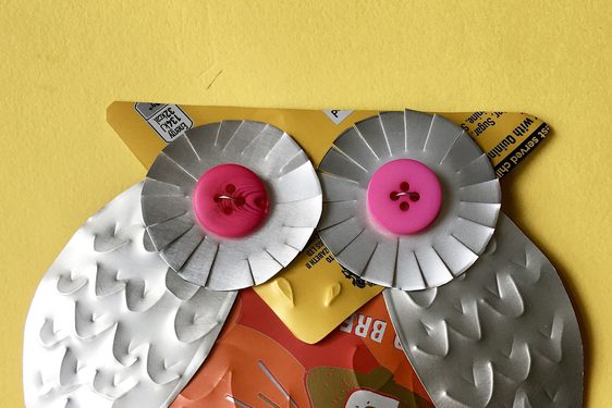A stylish owl badge crafted from a fizzy drink can.