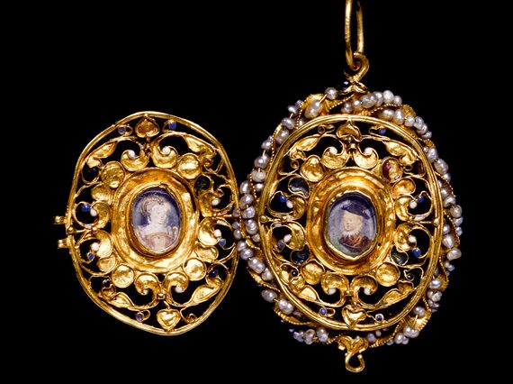 An elaborate gold locket with pearls around one of its edges. It is open to reveal a portrait of a woman and of a boy.