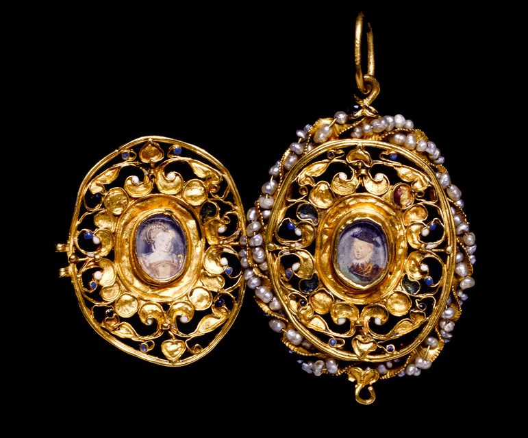 An elaborate gold locket with pearls around one of its edges. It is open to reveal a portrait of a woman and of a boy.