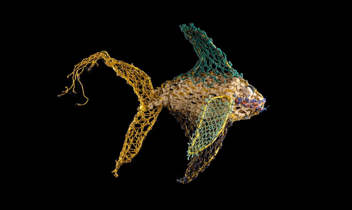 A fish sculpture made of colourful ghost nets.