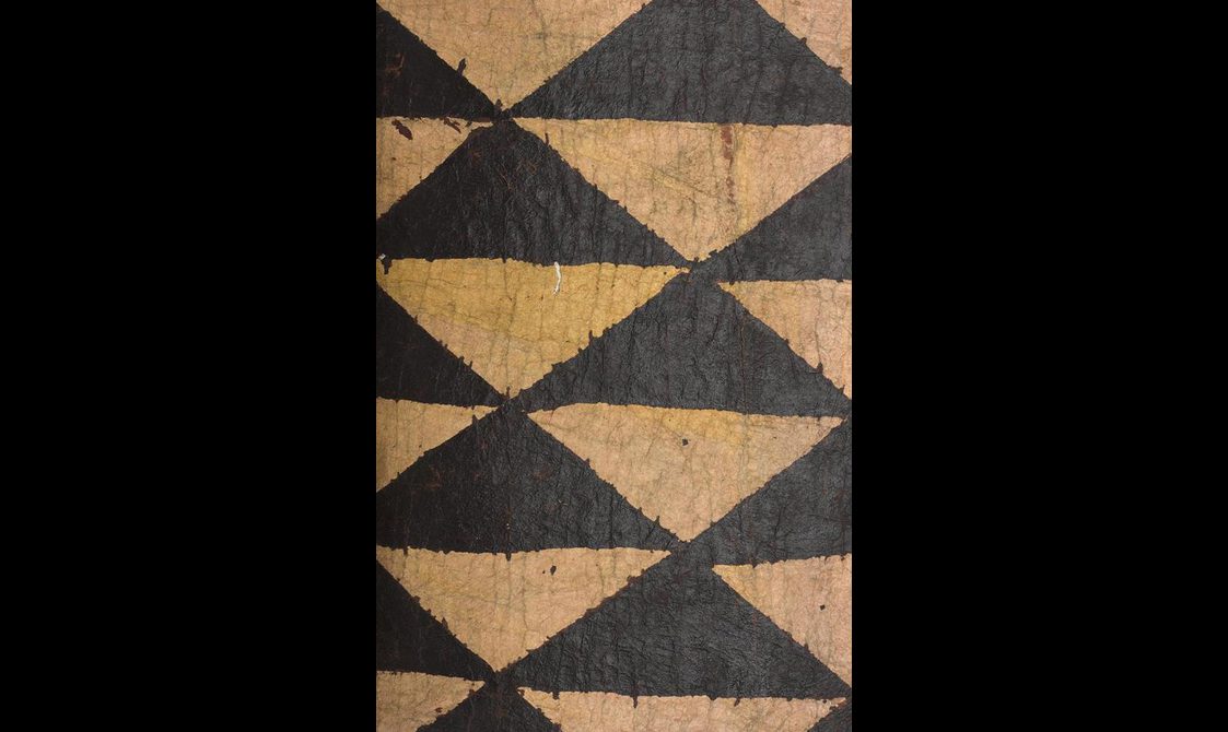 Black triangles are painted against yellow bark cloth.