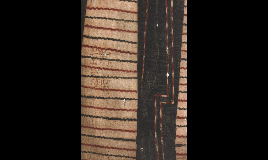 Yellow barkcloth with interchangeable wavy horizontal black and red stripes and a vertical black area on the right hand side.. Further two vertical red and yellow lightening shaped lines are drawn against the black area.