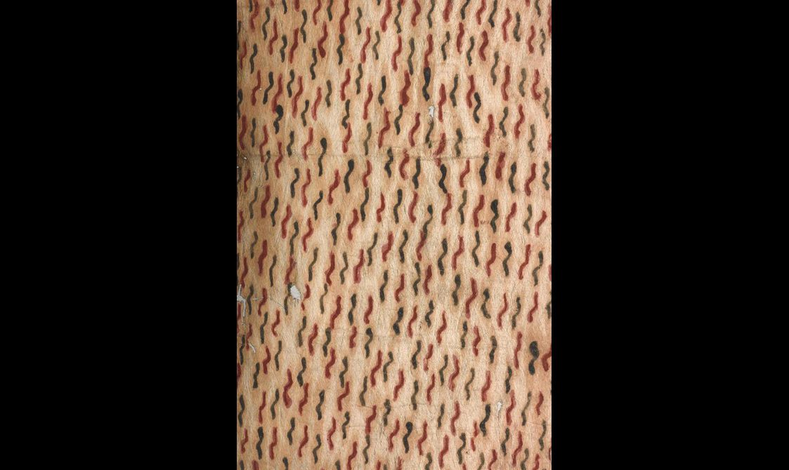 Detail of a yellow barkcloch decorated with interchangeable wavy worm shaped red and black lines.