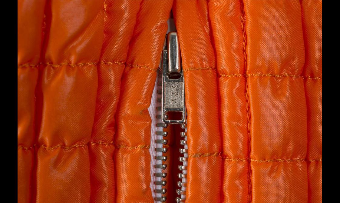 Close up of an orange puffer jacket.