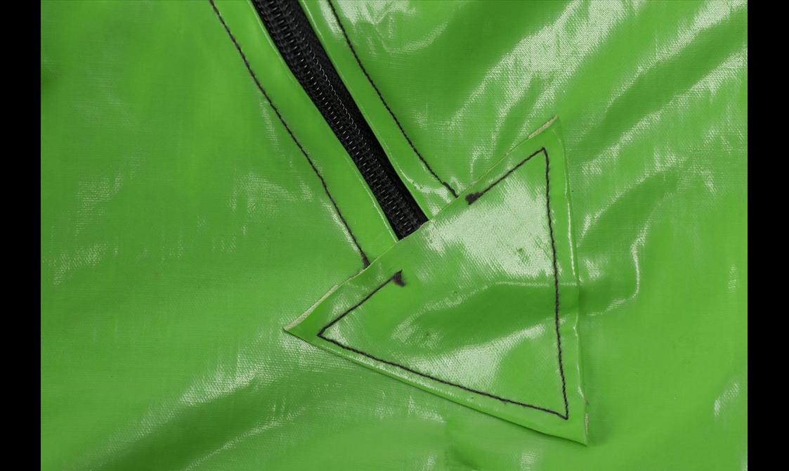 Close up of a green PVC jumpsuit.