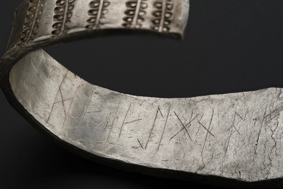 A close up of the runic inscription on the inside of the Galloway Hoard silver arm ring.