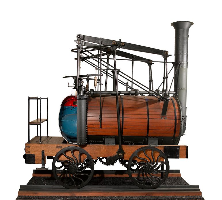 A model of train steam engine in wood and iron.