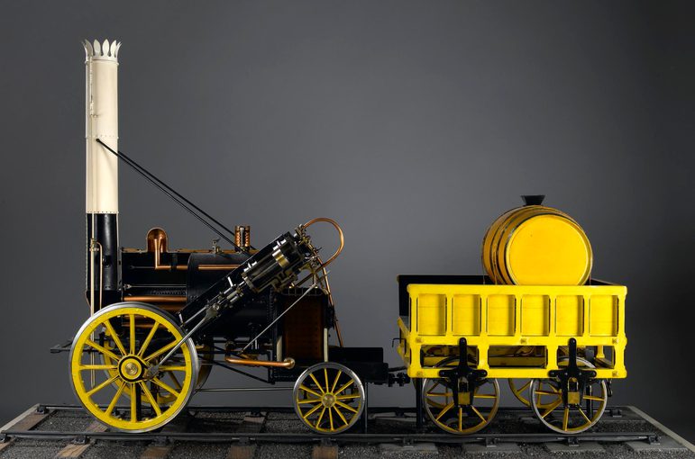 A model of a black and yellow steam engine train.