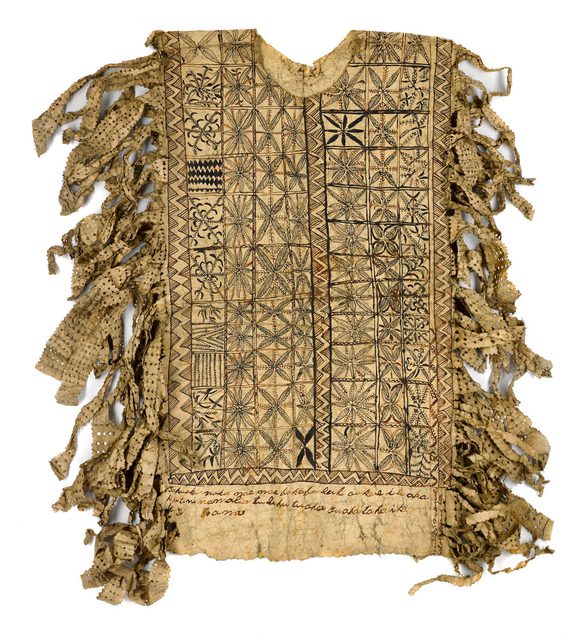 Light brown hiapo (barkcloth) tiputa with decoration on the front and back including text, and pierced tassels.