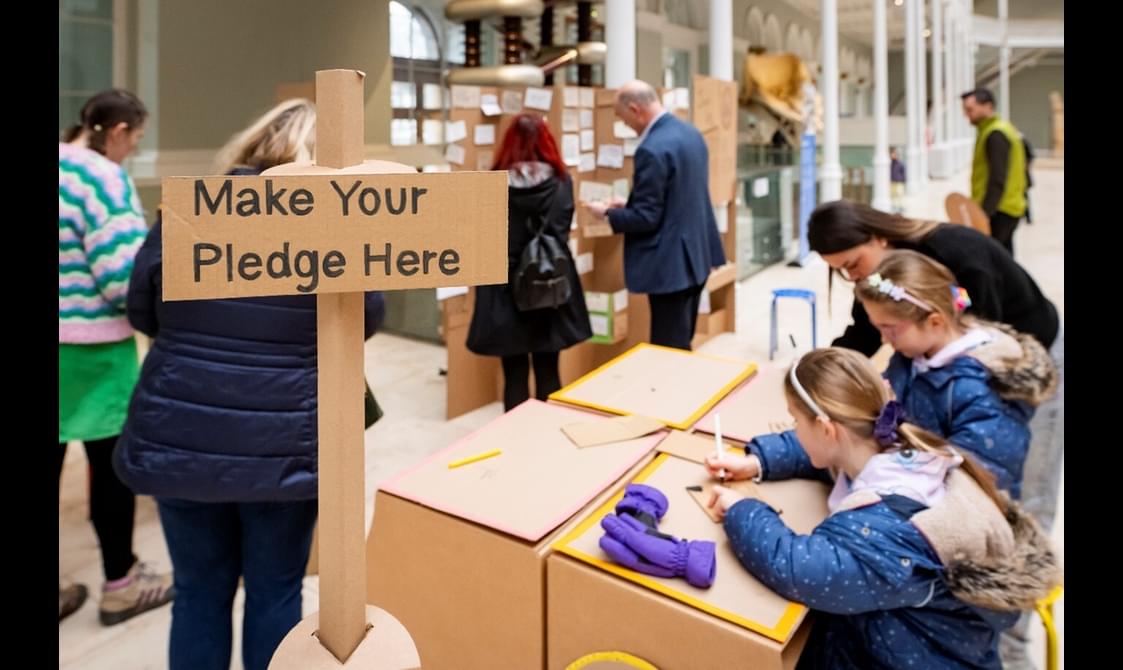 People are writing their climate pledges at the National Museum of Scotland