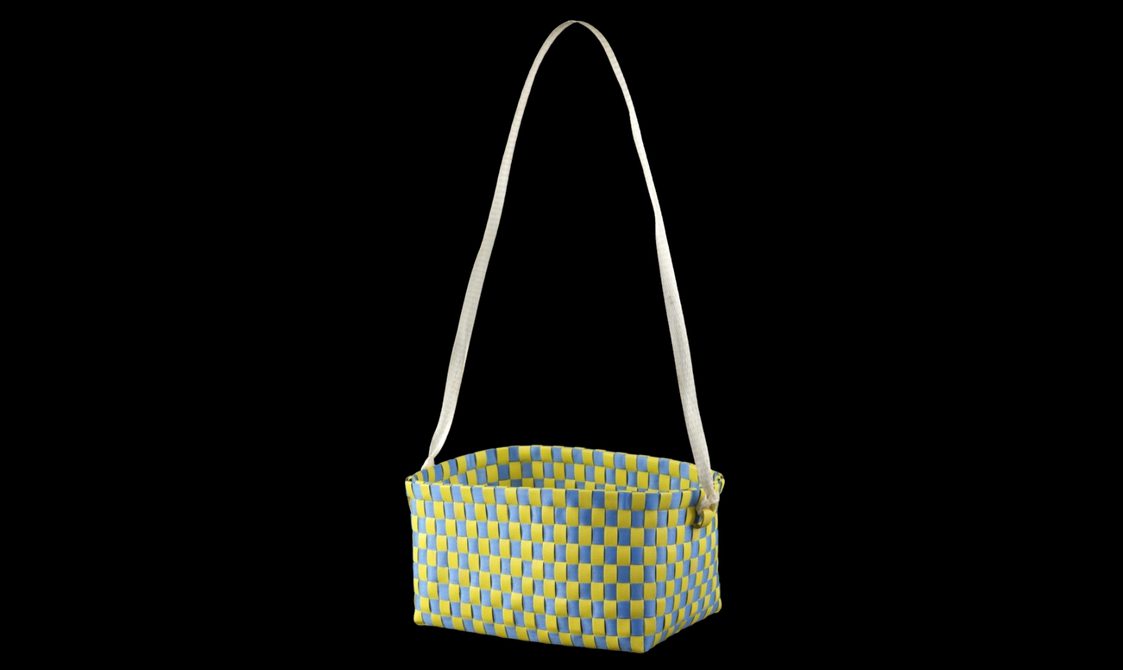 A blue and yellow basket with strap woven from plastic.