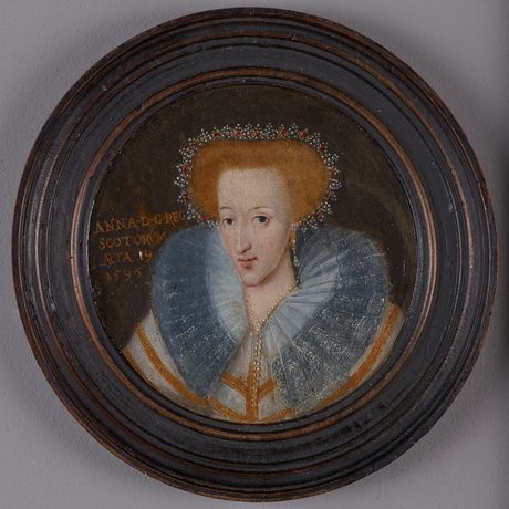 A painting of a woman with red hair surrounded by jewels wearing a dress with a large blue collar and jewellery. The painting is round and is framed with a dark wood circular frame.