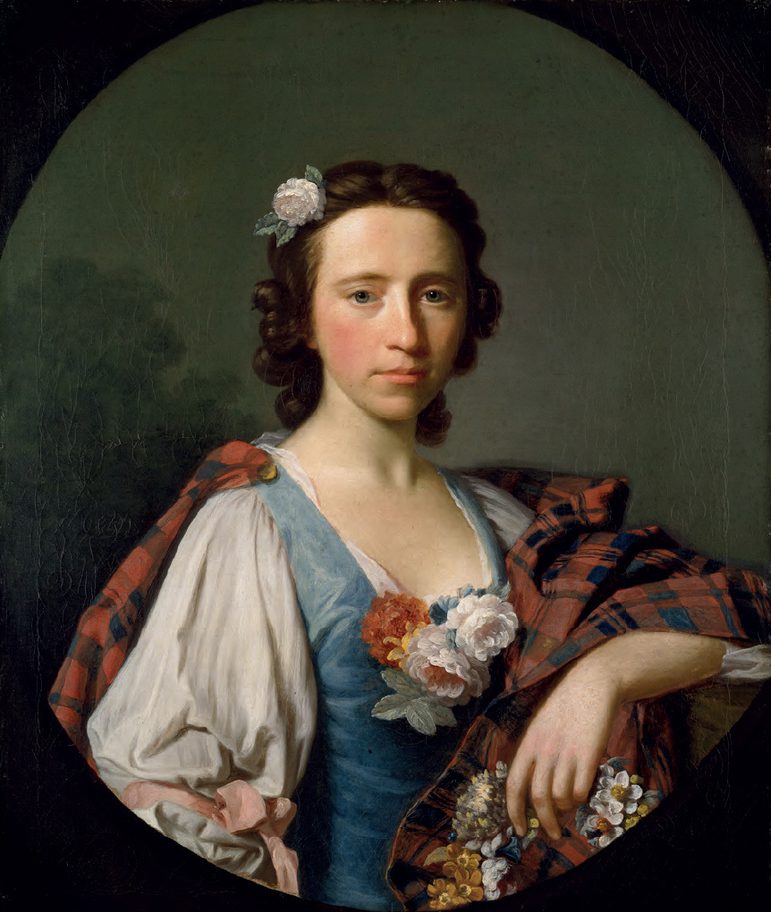 a painting of a woman shown from the waist up. She has curled brown hair and is wearing a white blouse with puffy sleeves, blue corset, and a tartan shawl with flowers pinned in various places.