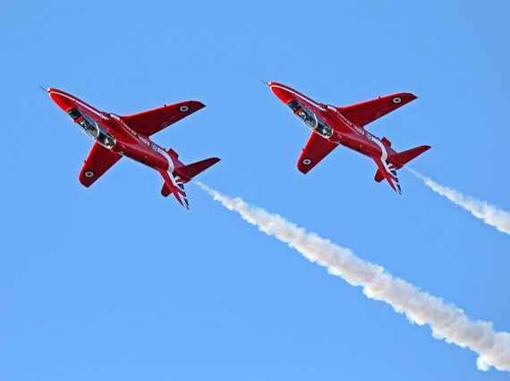 Two Red Arrow Hawk aircraft flying upside down.