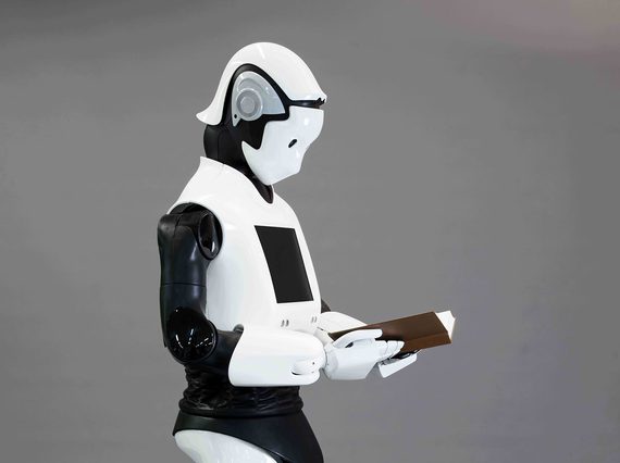 A white robot reading a book.