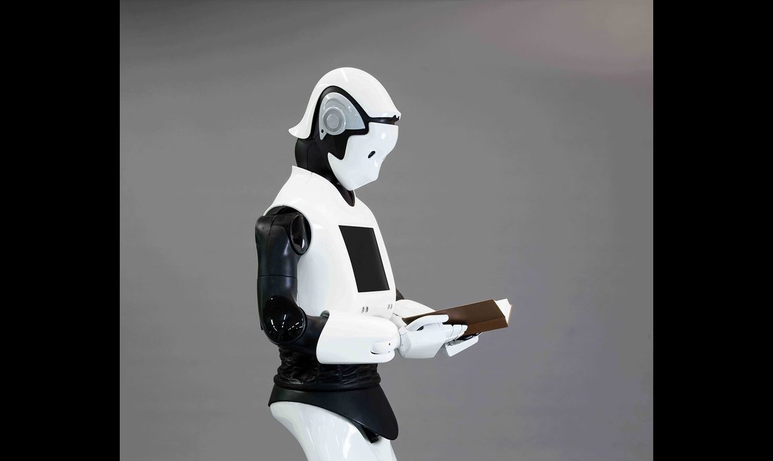 A white robot reading a book.