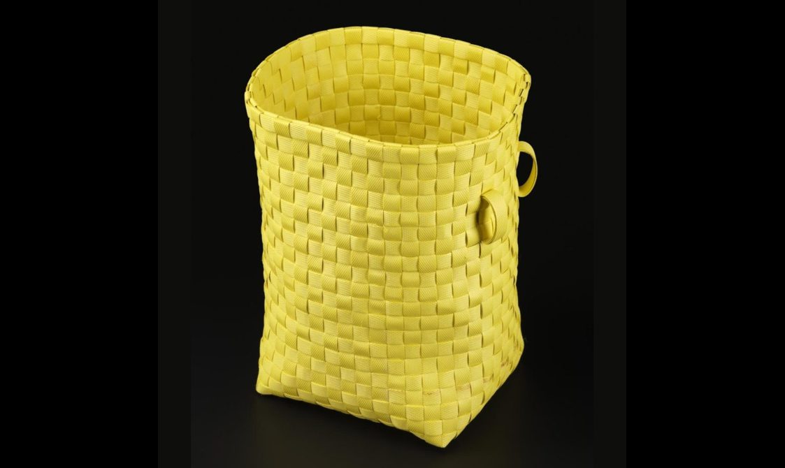A tall yellow basket woven from plastic.
