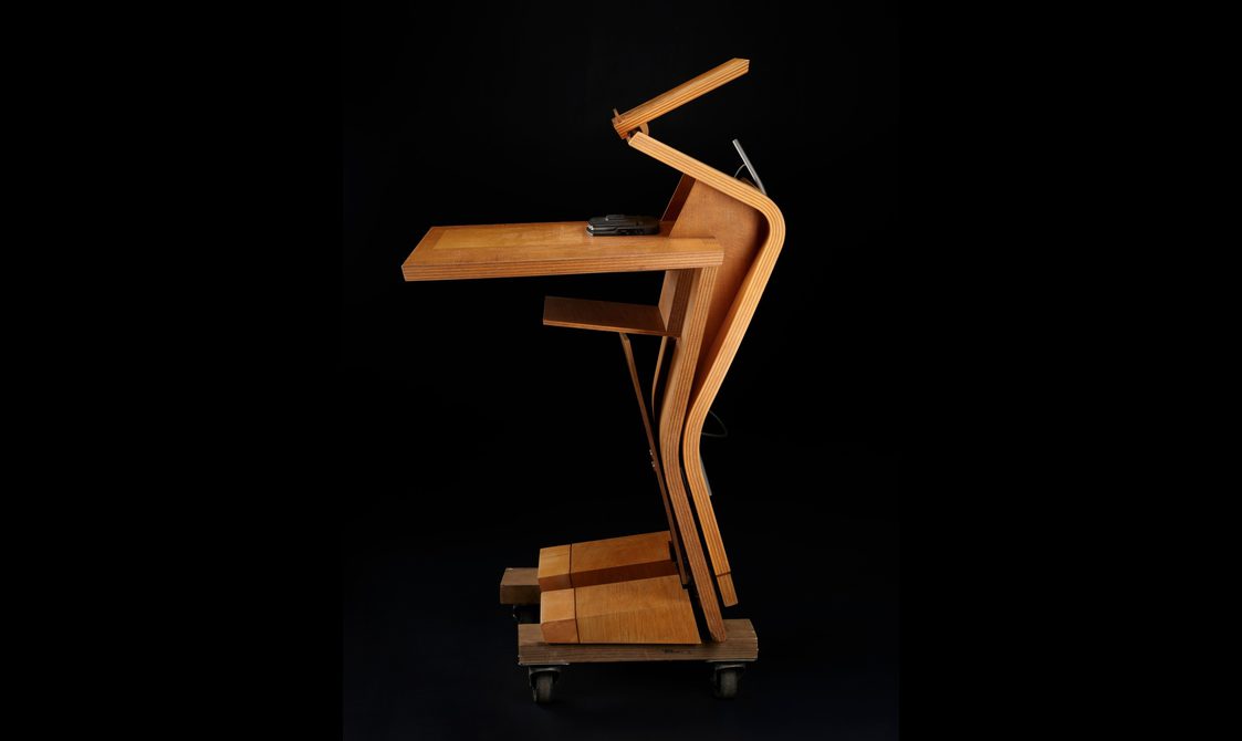 Side view of the desk, emphasising its humanoid shape and zizag curved frontage.