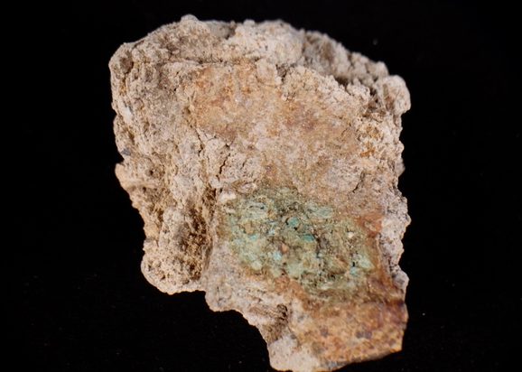 1 lump of grey looking stone with a bit of green, otherwise without defining features.