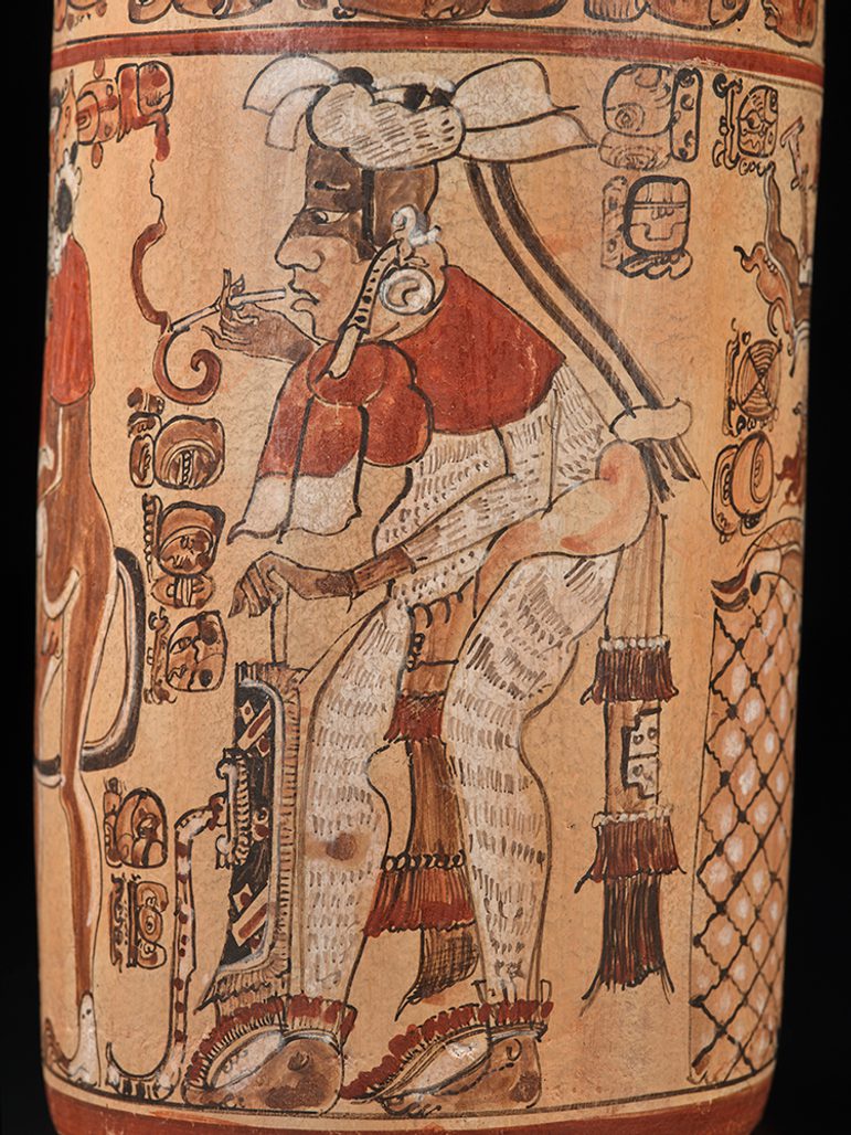 Mayan vase depicting a smoking man surrounded by intricate symbols and glyphs.