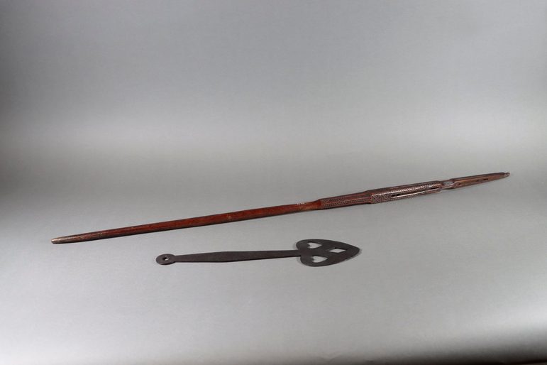 2 long tools, one with a pointed end and one that is curved like a spade.