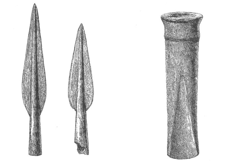 A black and white illustration of two spear heads and a tool with a round opening and a flattened edge