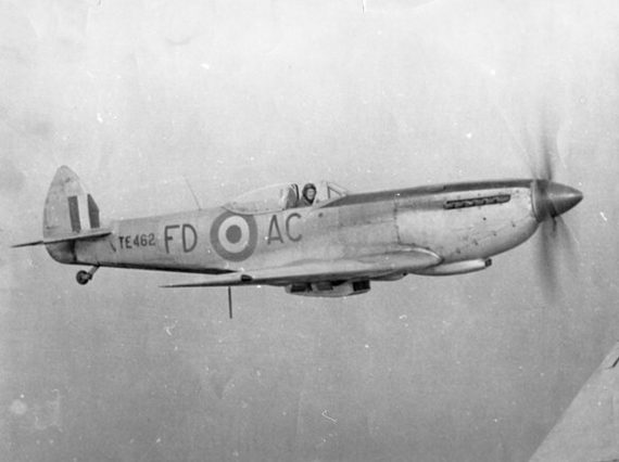A black and white photograph of a pilot flying a spitfire aircraft.