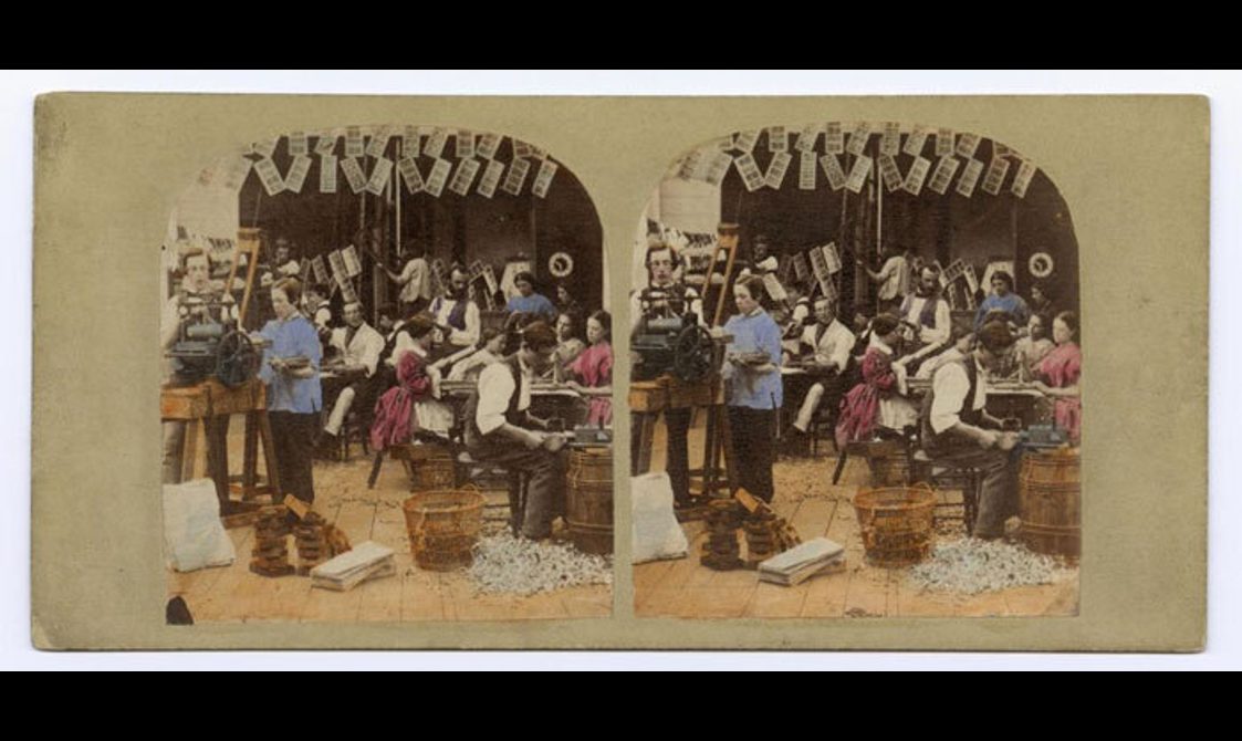 Two old photographs of people working in a Victorian stereocard studio. The images are coloured and are mounted side-by-side on an aged cream mount.