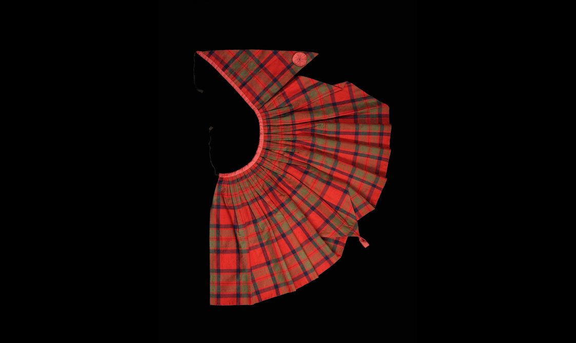 A semi-circle piece of tartan fabric with gathers along the top