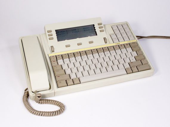 A cream telephone, with a receiver on one side and a keyboard on the other. A small screen sits above the keyboard.