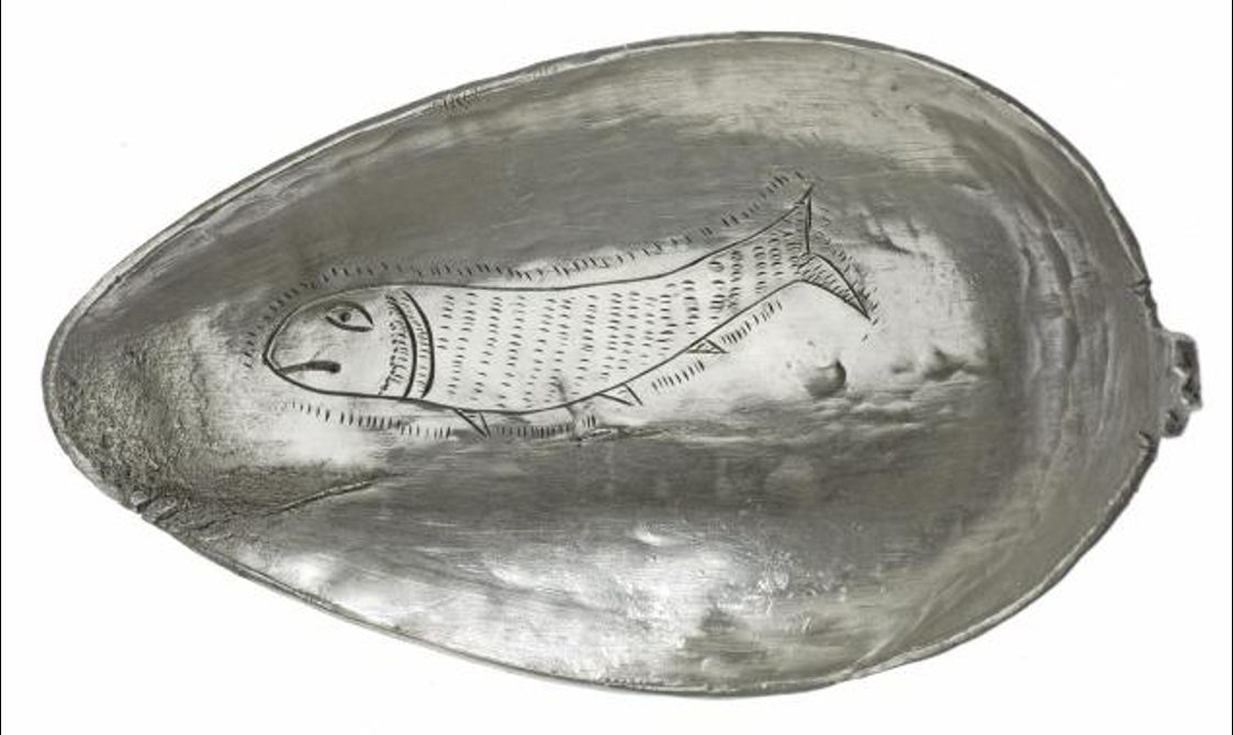 Silver spoon head detail with an engraved fish decoration