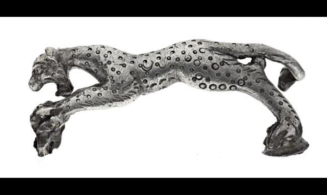 Leaping panther with its mouth open, decorated in punched design circles.