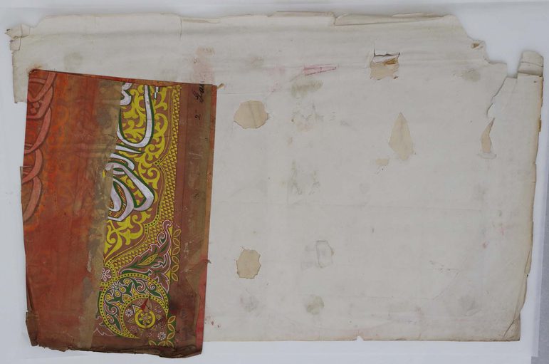 A piece of tracing paper is used to protect the paper during conservation