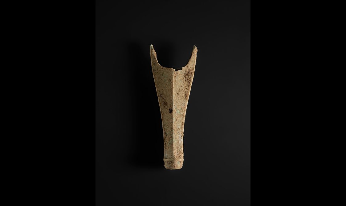 An elongated bronze chape