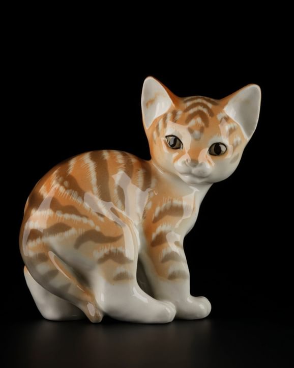 An ornamental cat with orange and brown stripe markings.