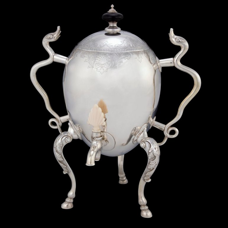 A silver urn with ornate handles