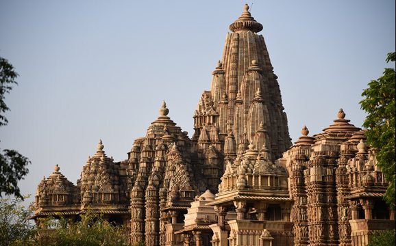 A highly ornate temple, pictured in front of a clear blue sky