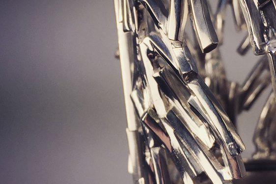 A detail of a sculpture made of jagged silver pieces