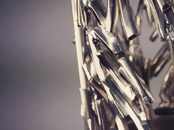 A detail of a sculpture made of jagged silver pieces