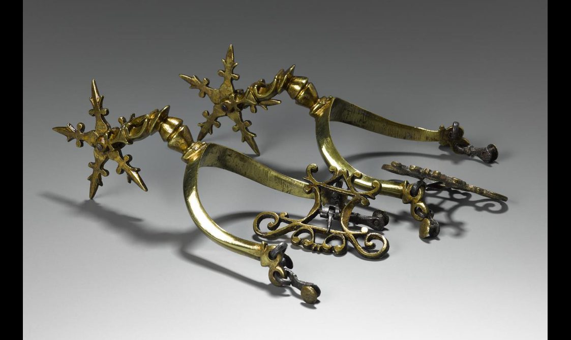An elaborate set of gold spurs