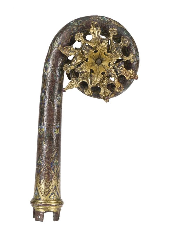 The head of a wooden crozier with gilt bronze detail on an ornate leafy design